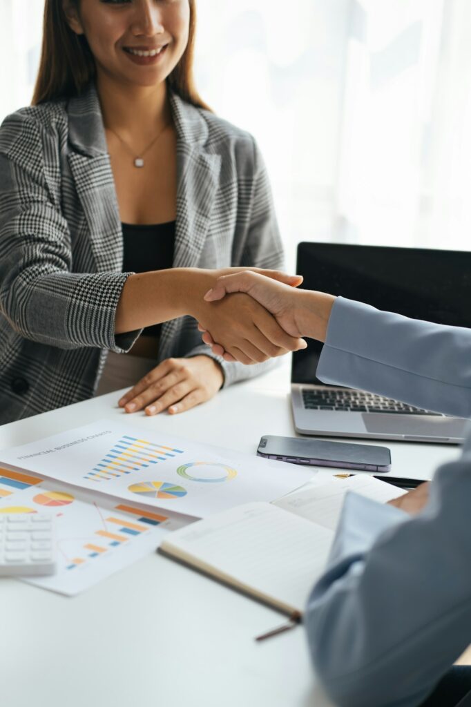 Image of businesswomen having a handshake after finish the meeting.